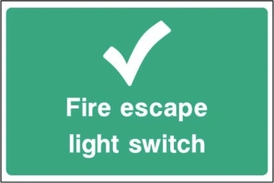 Fire escape light switch sign showing tick symbol and switch identification. Artwork EMER0096.