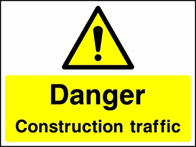 A black exclamation mark inside a yellow warning triangle above black wording on a yellow panel with Danger — Construction traffic wording. CONS0103 artwork.