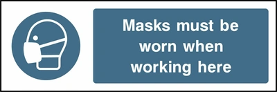 Masks must be worn when working here sign showing blue face mask pictogram beside wording. Artwork PPE0012.