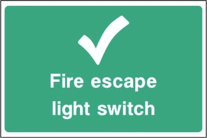 Fire escape light switch sign showing tick symbol and switch identification. Artwork EMER0096.