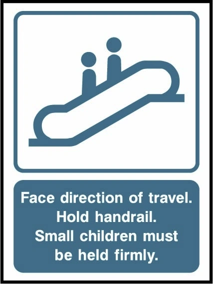 Face direction of travel — Hold handrail — Small children must be held firmly sign showing escalator illustration above three safety instructions. Artwork LIFT0021.